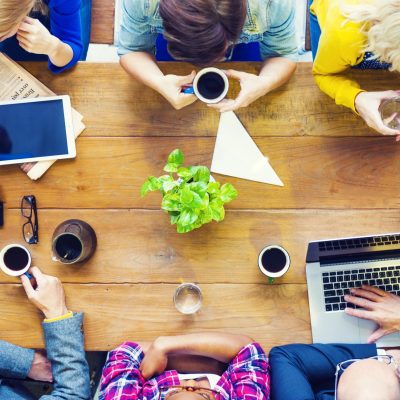 Multiethnic People with Startup Business Talking in a Cafe Multiethnic People with Startup Business Talking in a Cafe
